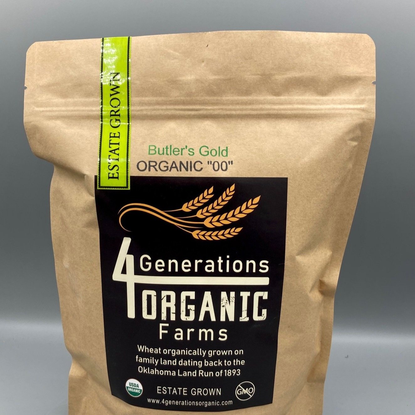 Brown paper bag of 4 Generations Organic Farms Butler's Gold Organic "00" wheat, labeled as estate grown and USDA organic, highlighting its heritage linked to the Oklahoma Land Run of 1893.